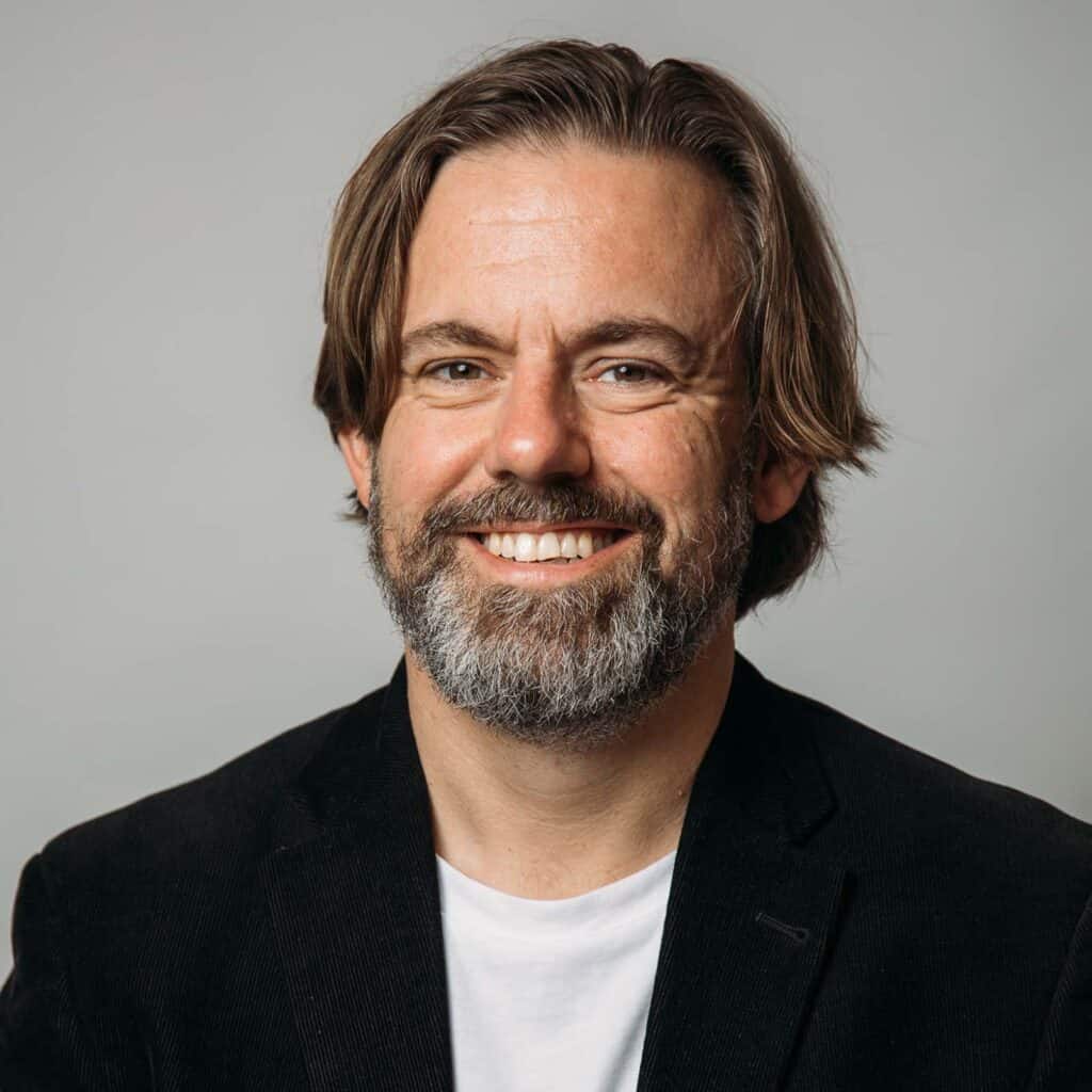 Another headshot of David McGuire. He no longer has long hair like he does in this photo, but he liked the pics so much he hasn’t updated them.